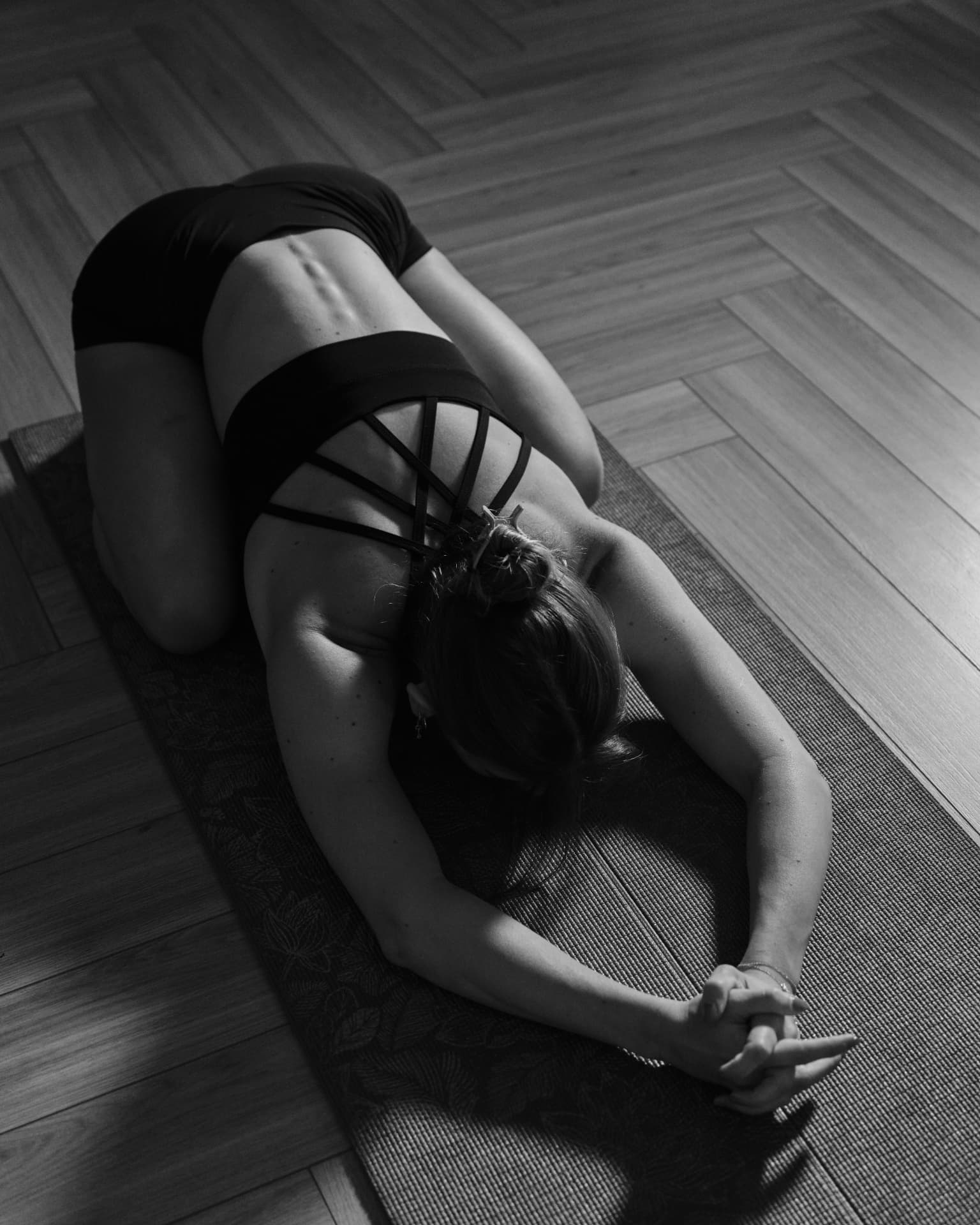 A member in child's pose on the yoga studio floor